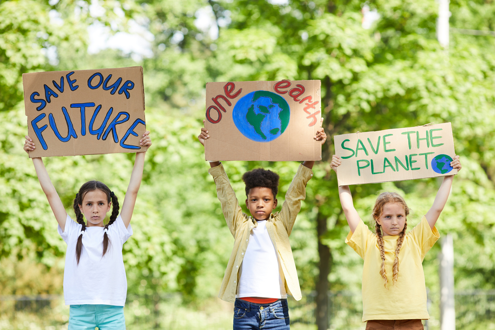 photo of children with save the earth signs